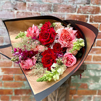 Thumbnail for Bouquet of deep red and pink roses with seasonal flowers of snapdragons and stock