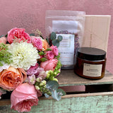 bouquet of flowers in hamper with Loco Love chocolates, bath salts and a scented candle